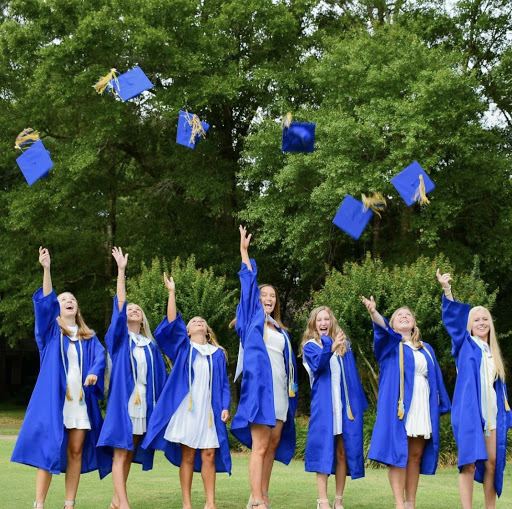 Ready, set, graduate... Seniors celebrate before the ceremony with a traditional cap toss photo. Photo by Molly Meilunas.