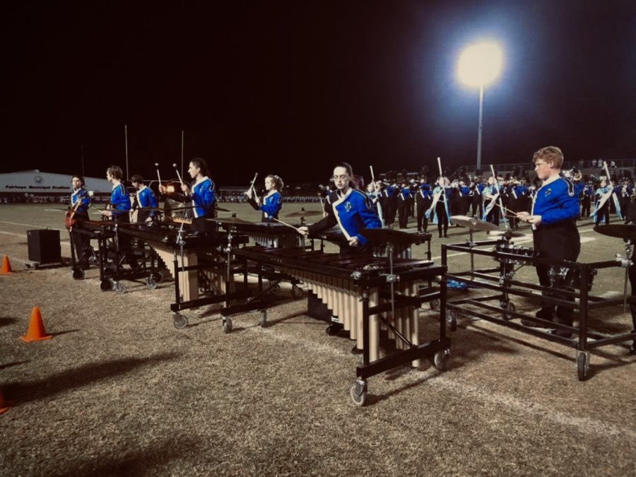 Time to shine. Front ensemble plays their part during the half time show. Members played their parts in the game performance to prepare for upcoming competition. 