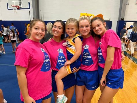 Beaming for joy... future cheerleaders pose for a picture after the clinic. Putting on the clinic has been something that the future and current cheerleaders looked forward to. 
