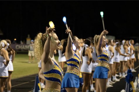 Light it up... The twirlers light up the sidelines during the game. Photo by Sharon Pippin.