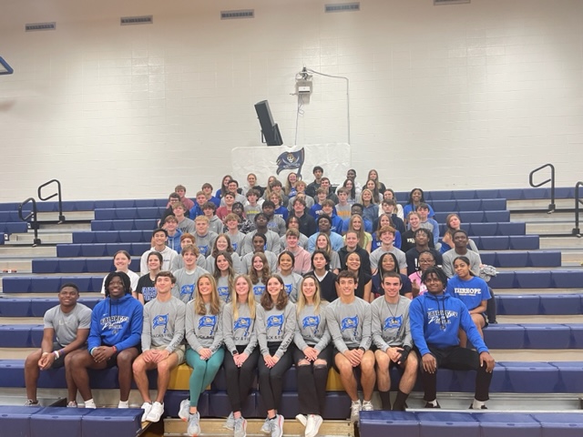Smile for the Camera! The indoor and outdoor track teams enjoy time together in the Fairhope High school gym. 