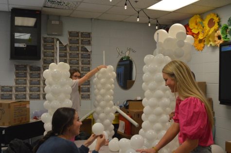 Building the foundation... Juniors and seniors help make a Greek-themed arch for Prom decorations. Photo by Jillian Surla