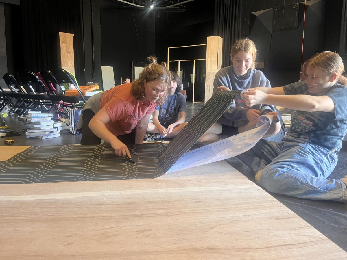 Set and ready…Hannah Rogers, Maggie Ray Brown and Victoria Hardy wallpaper flats. They designed the set of “The One-Act Play That Goes Wrong.”