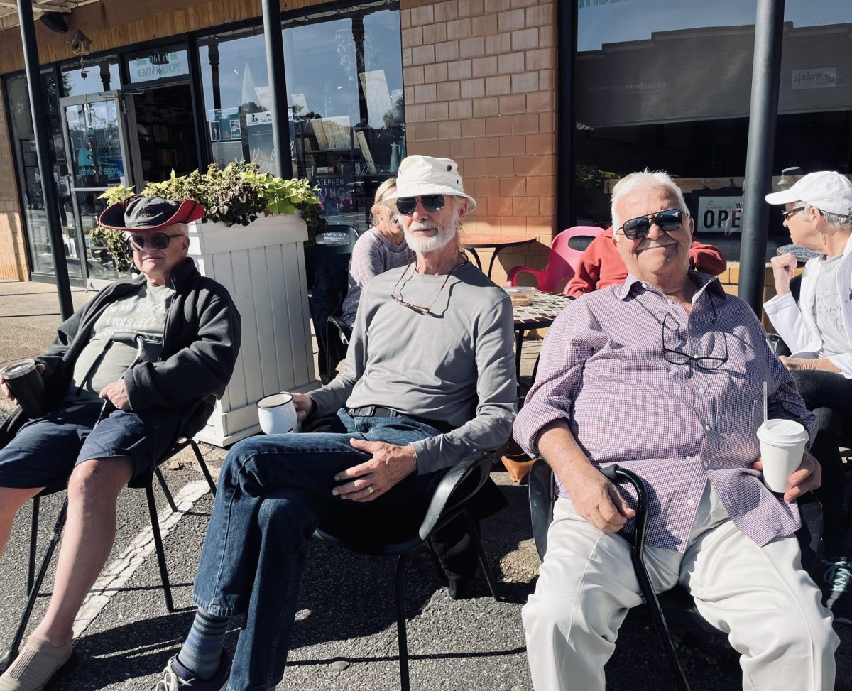 Coffee and watching… Chuck Armbruster, Jerald Nuber and Ron Johnson enjoy their coffe while watching the Veterans Day parade in Downtown Fairhope Saturday morning. “Were just three old veterans,” Nuber said.