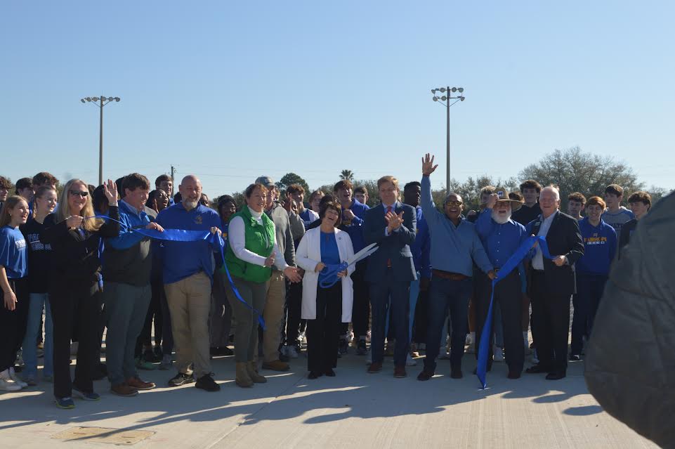 Celebrating new beginnings... School staff along with Baldwin County school and city officials participate in the ribbon cutting ceremony of the new facility. Mayor Sullivan announced that the track will serve the high school team and the community alike.