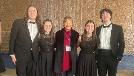 United by song… Eliana Steiniger, Rawlin Hoffman, Reuben Rockwell, Nicole Denham and chorus teacher Diane Ham save their memories at All-State 2024. Every year, they take the same photo.