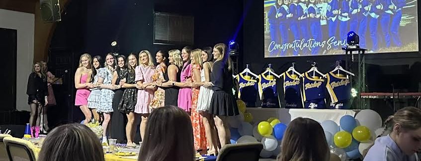 Awards all around…Senior cheerleaders take the opportunity for their final group picture. 