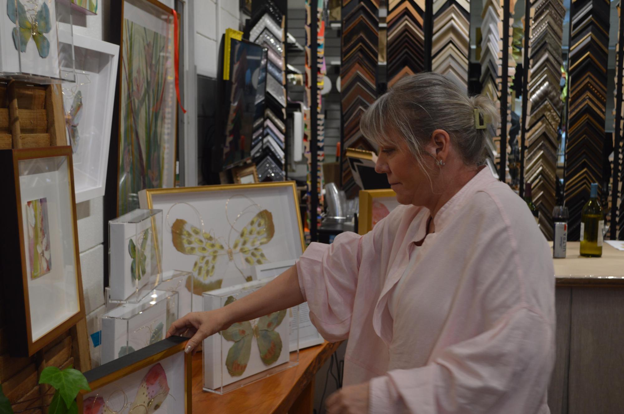 Proud moment… Kelley Lyons owner of Lyons Share Gallery admires her art.