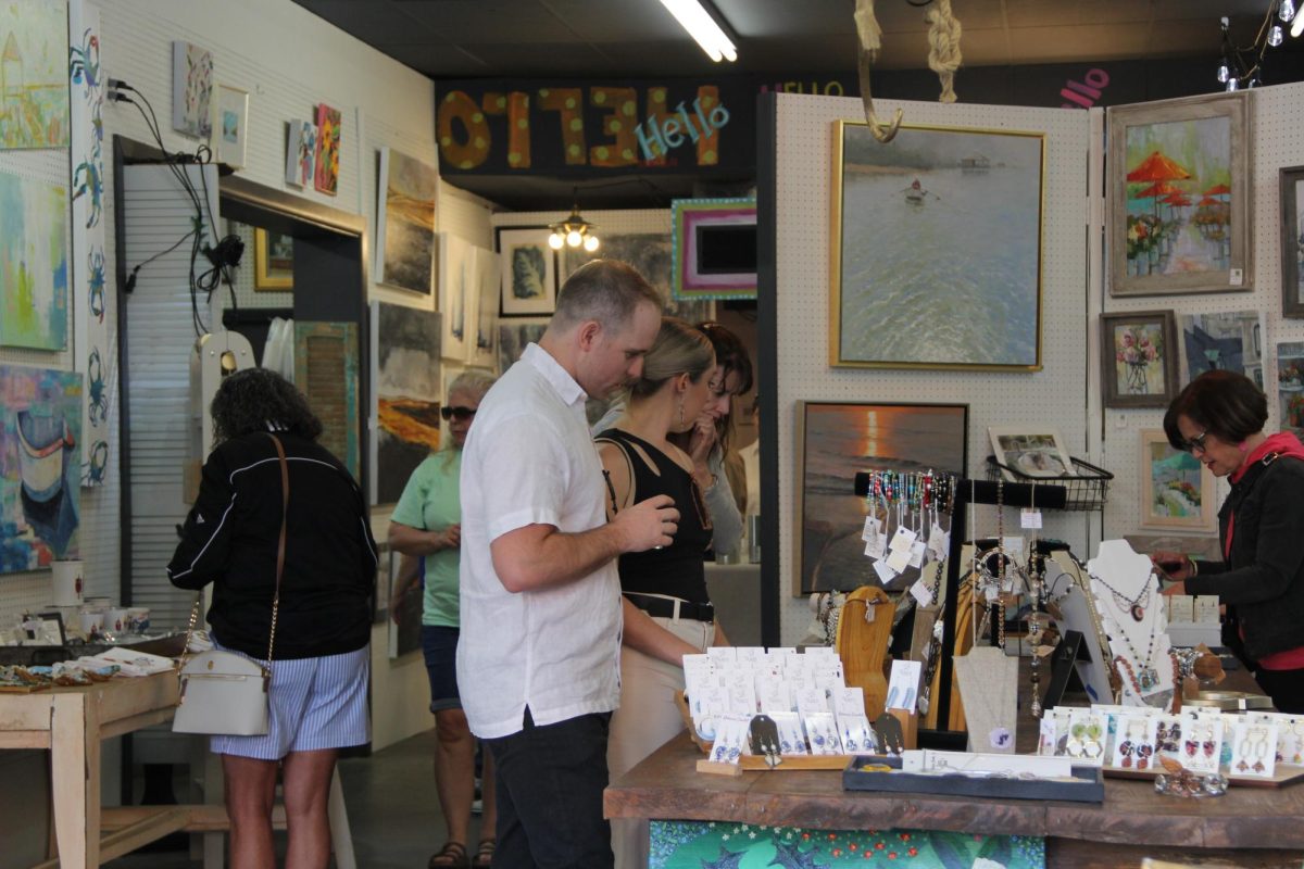 Celebrating First Friday… Vacationers and locals browse through merchandise on Fairhope Avenue. Seeley’s Gallery by the Bay hosted First Friday Art Walk for locals and tourists. 