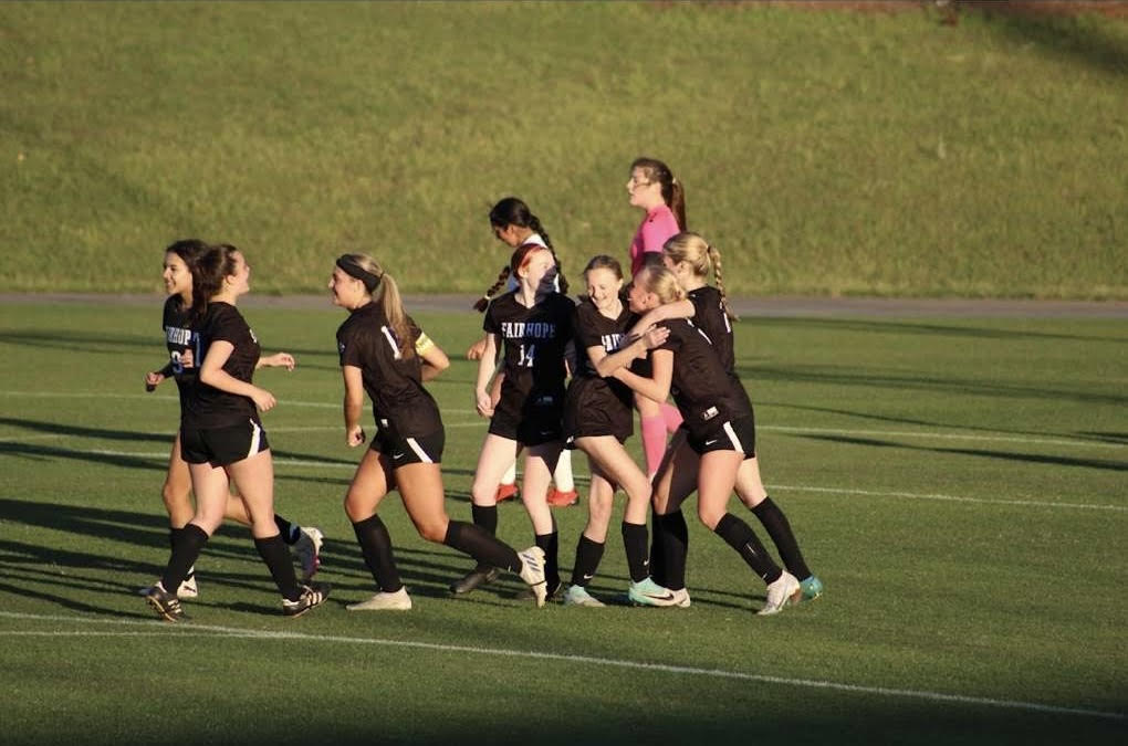 Scoring big… Senior Aidan Hagan celebrates her goal with her teammates. She scored her second goal putting the Pirates up 2-0.