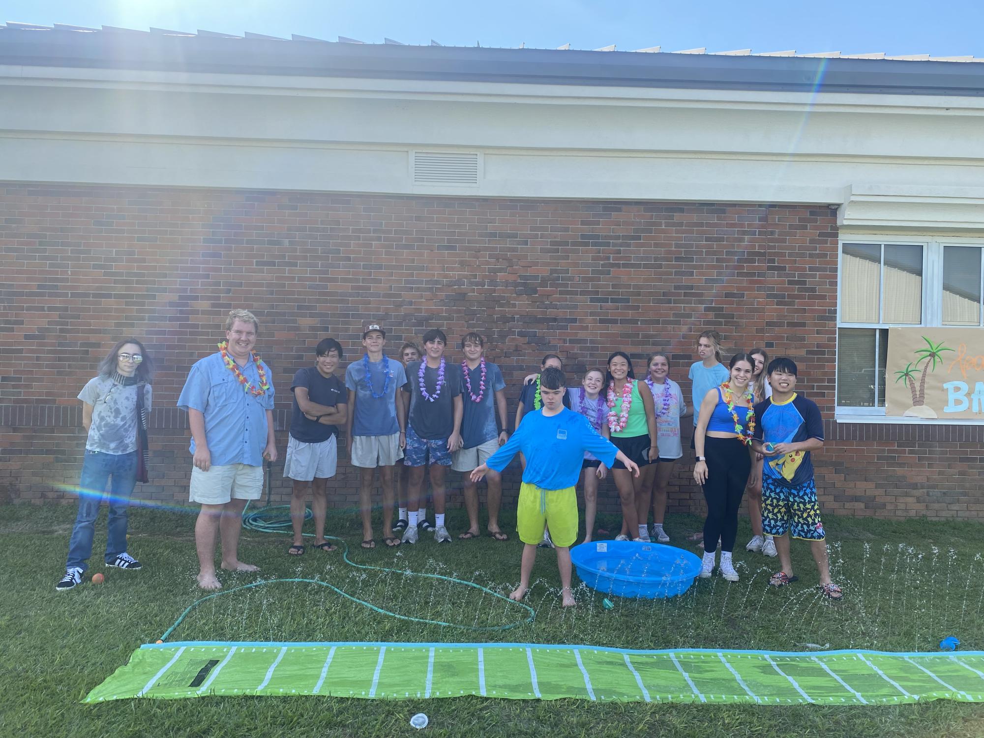 SPIN N’ SLIDE…Operation Jubilee volunteers and students play on the waterslide. They enjoyed the camaraderie with their peers. 