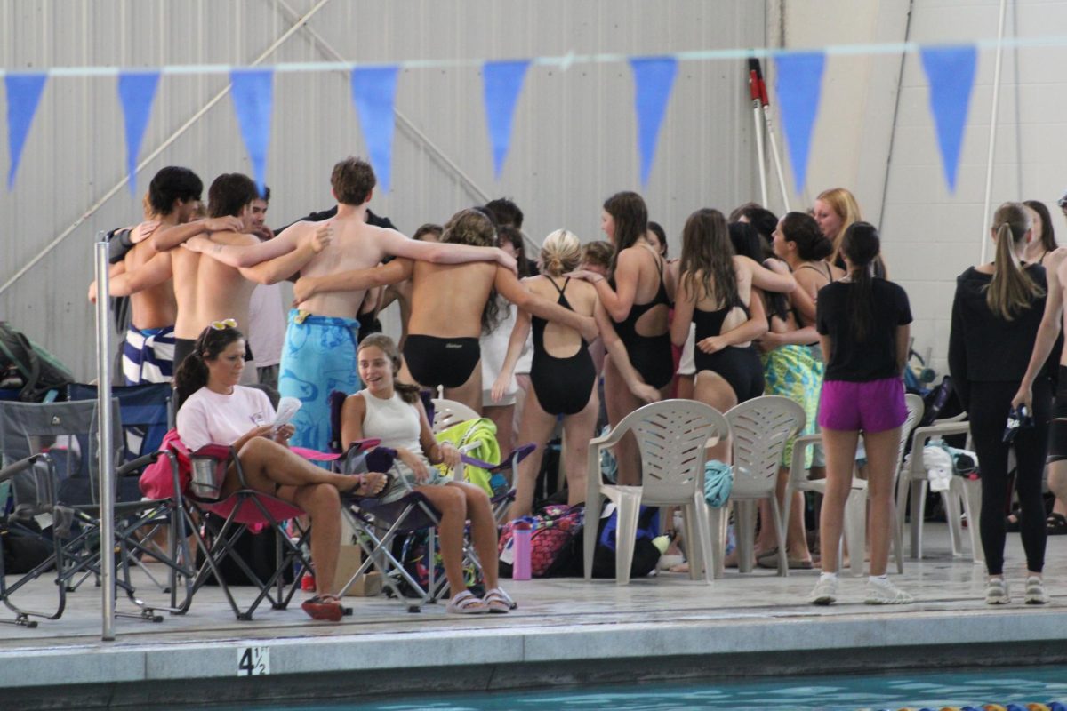 Go team go!... The Fairhope swim team huddles and chants. The team won first place. “I think swimming is both mentally and physically challenging; some events impact more mentally, though. For me it's the 50 free,” said Roderick Farrington, sophomore.