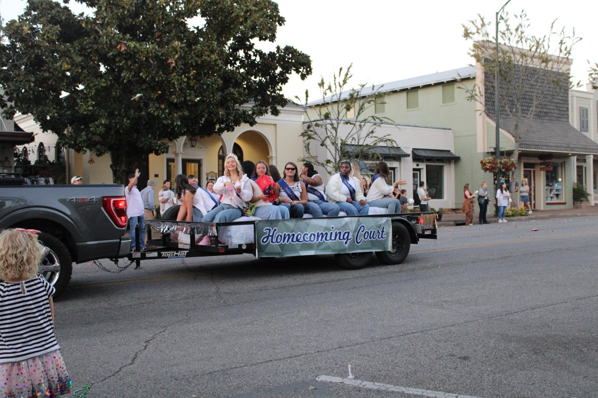 Cheers for the court… Homecoming queen Mary Chapel Whitehead leads the float and tosses treats out to the crowd. The parade date was postponed to October 23 because of inclement weather the week of homecoming.