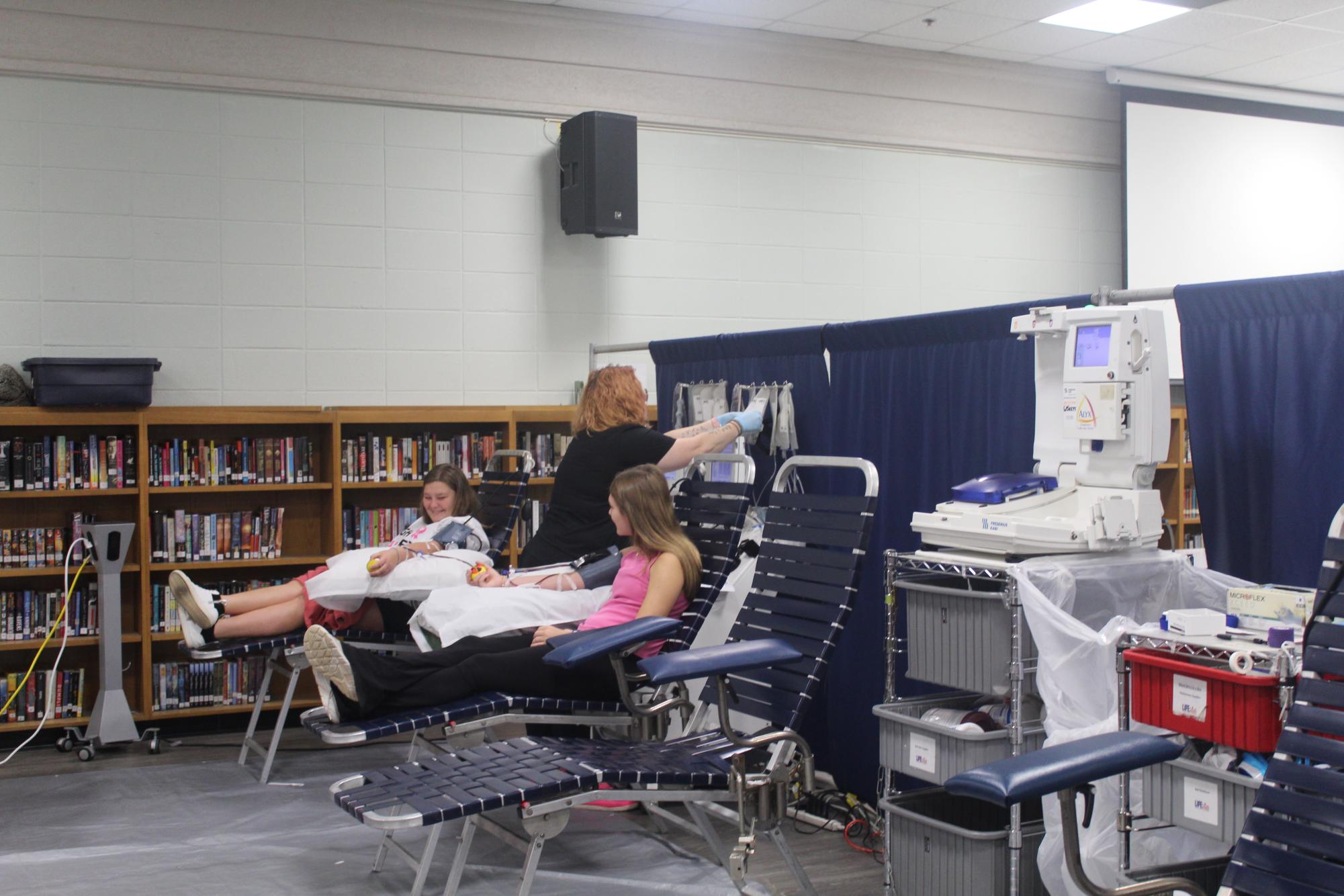 GIVING BACK… Juniors Kaitlyn Jones and Kaitlyn Kalagher donate blood on Thursday. Jones also donated platelets, which went directly to cancer patients. “The process was very laid back,” Jones said.