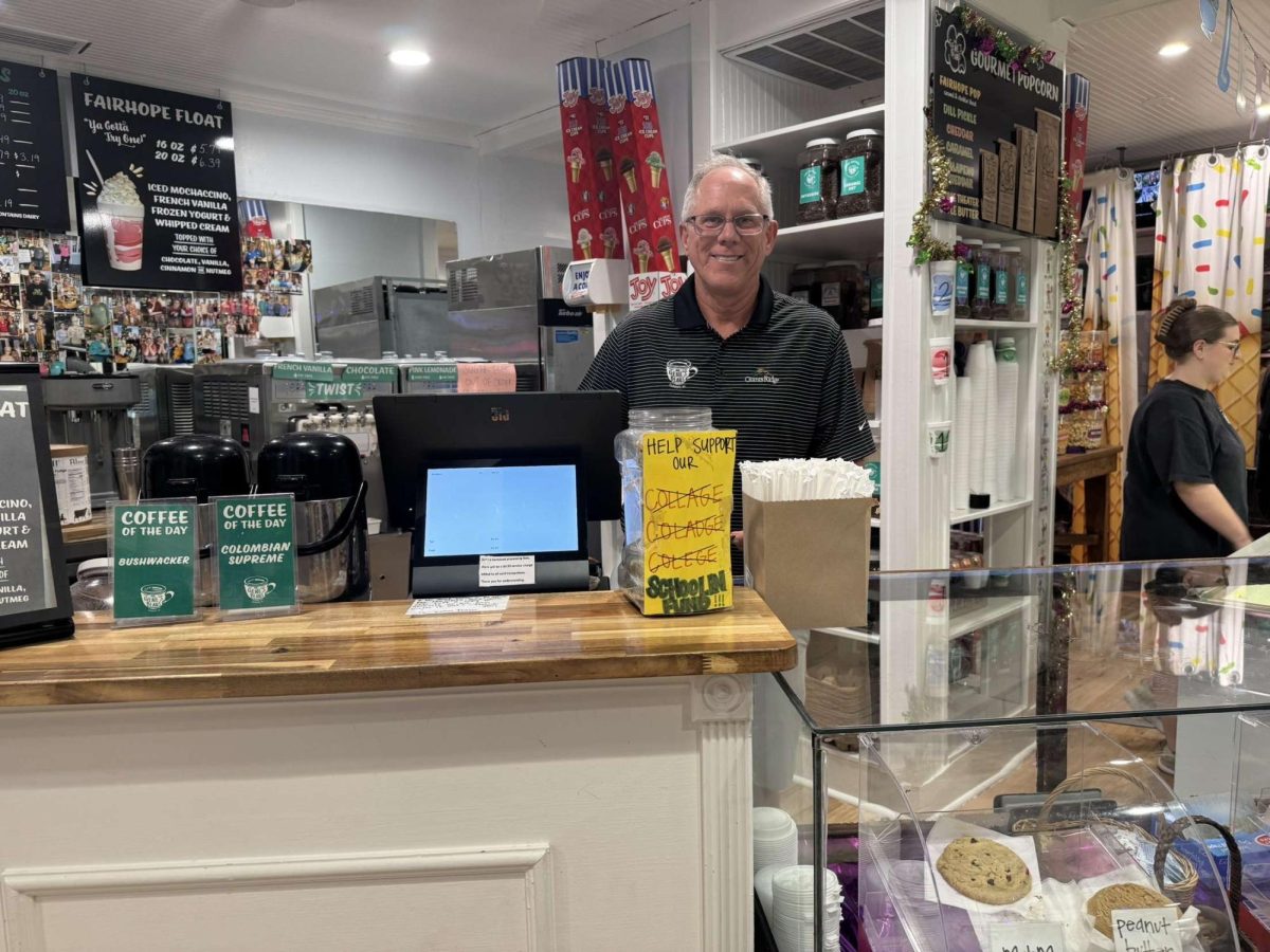 We all Scream for ice cream!... Gene Beans owner Chad Bartz helps his workers serve ice cream at the First Friday art walk. “ I love to help out and see everyone that comes in,” Bartz said.