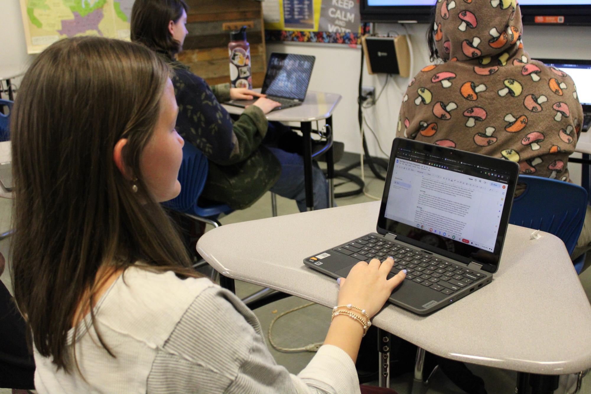 Typing away… Senior Piper Berry types paragraphs reflecting on her trades as a part of the project. Berry started with a pen, and through a series of ten trades, she ended up with a water gun and floatie.