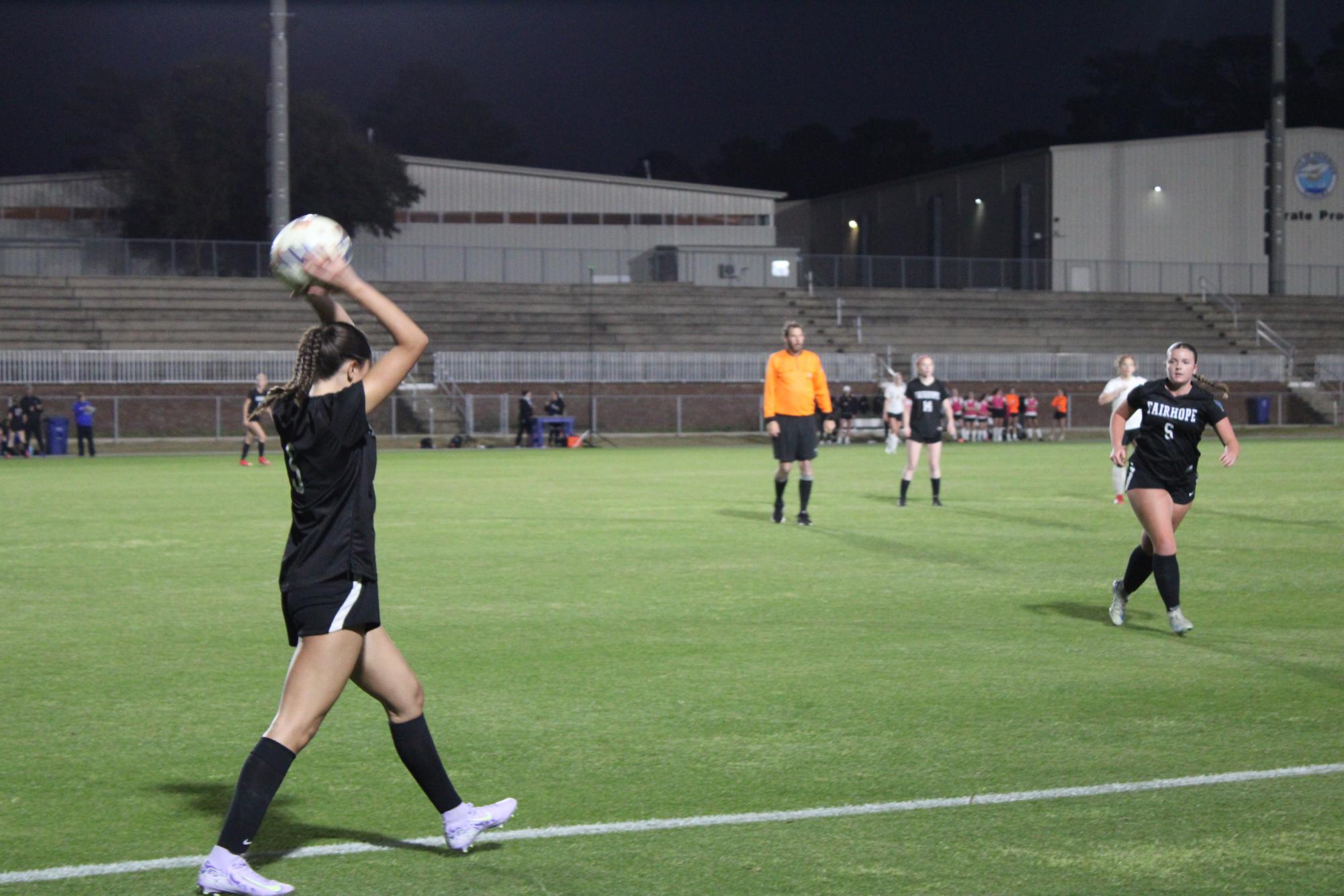 Throw in… Senior Kadence Torres throws the ball to Senior Anna Laraway at Volanta field against McGill-Toolen on March 11. The Lady Pirates lost 1-0.