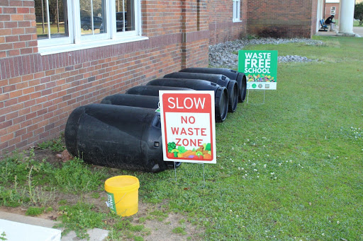 Worming through… Compost bins sit in front of Fairhope High School. FHS students supplied the waste within. Students rotate the bins regularly to allow for complete decomposition of the waste.