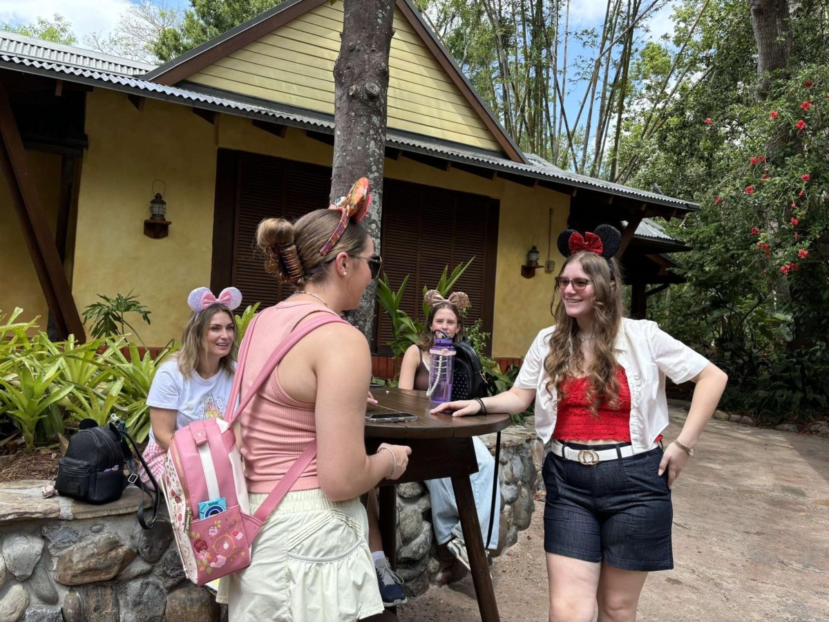 Meeting spot… Senior Jillian Surla and junior Bailey Harness meet up with their classmates before the storytelling conference. Students enjoyed spending the morning  shopping, eating and riding the attractions at Animal Kingdom.