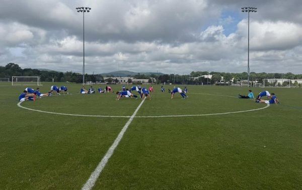 Stretching for Semifinals… The Pirates huddle together to stretch for an intense game. The players took their positions on the field and kept in condition. Submitted photo.
