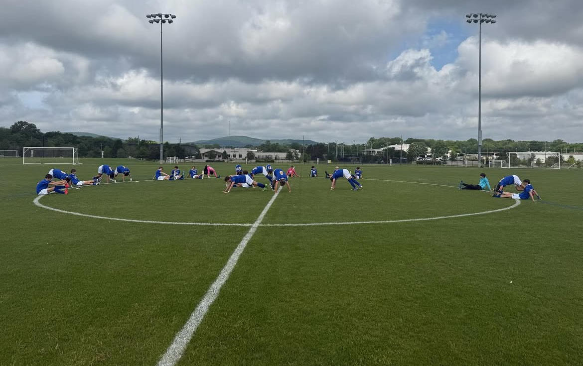 Stretching for Semifinals… The Pirates huddle together to stretch for an intense game. The players took their positions on the field and kept in condition. Submitted photo.
