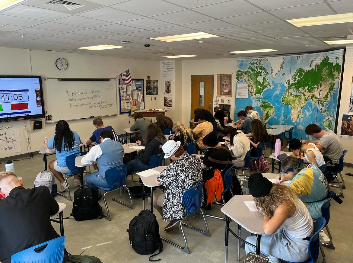 Work and play… IB seniors write a timed essay on the social policies of Joseph Stalin. Seniors completed this essay in their duo day dressup outfits on homecoming week. Photo courtesy of Fairhope High Instagram.