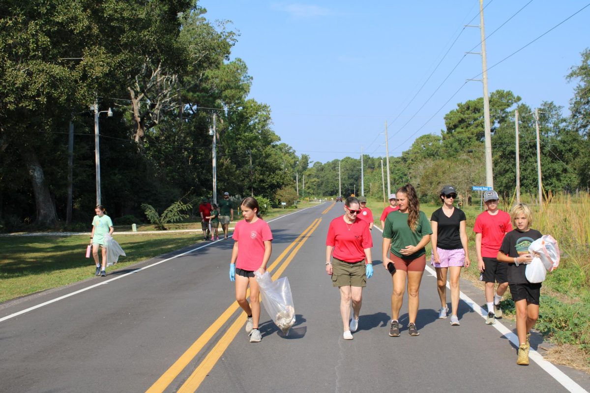 Group march… Troop 47 prepares to meet, get equipment and split into groups for Coastal Cleanup. After they split the scouts cleaned the street. (Jaden Zirlott)