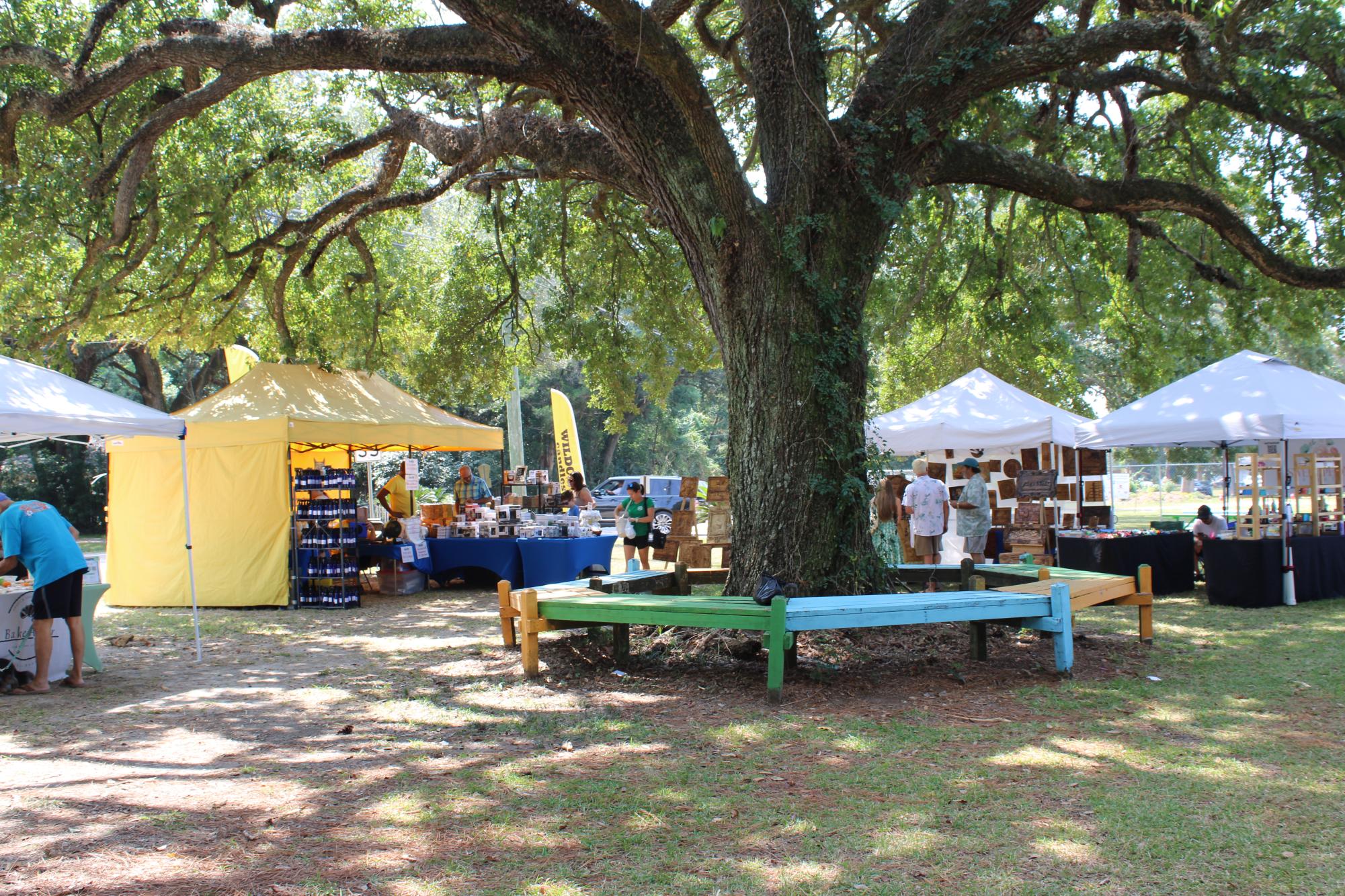 Ambling around the oaks… Visitors of the Mobile Bay Maker's Market interact with local vendors under the shade of a towering oak tree at the Anna T. Jeanes Campus in Fairhope on Sept. 21. 