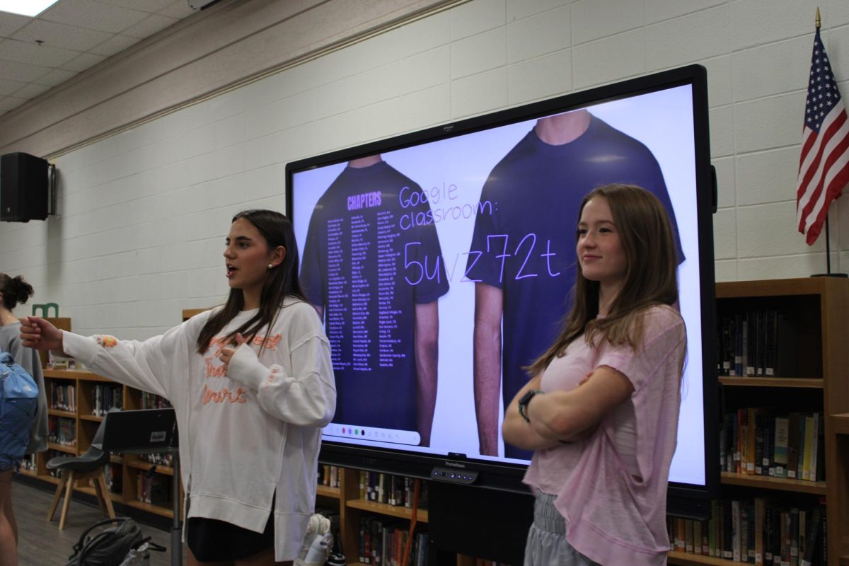 Instructions…Prues and Margaret Conyers tell members to join the Google Classroom and vote for t-shirts. Both Prues and Conyers have been officers for two years. (Halle Smith)