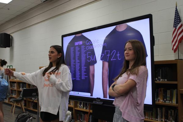 Instructions…Prues and Margaret Conyers tell members to join the Google Classroom and vote for t-shirts. Both Prues and Conyers have been officers for two years. (Halle Smith)