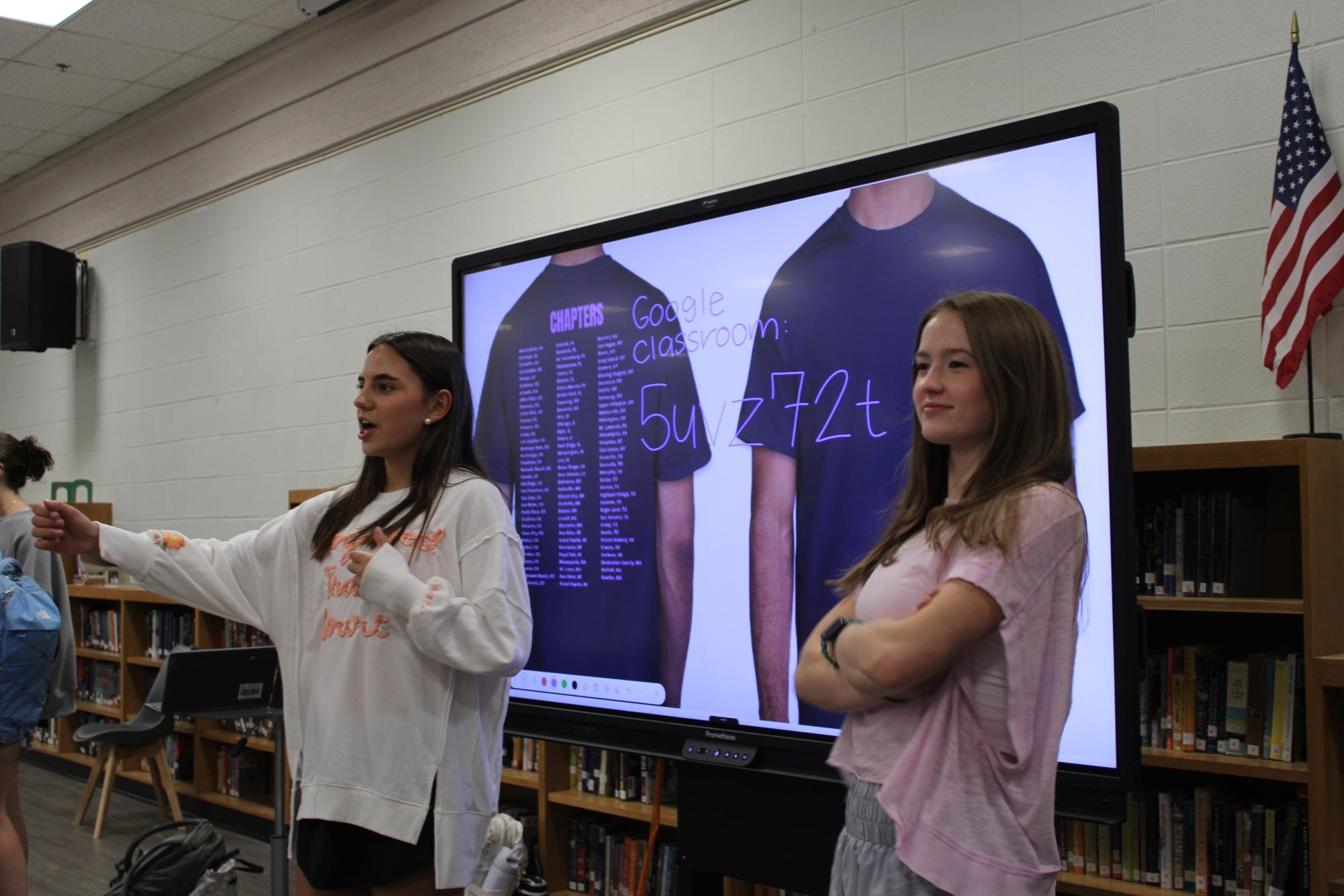 Instructions…Prues and Margaret Conyers tell members to join the Google Classroom and vote for t-shirts. Both Prues and Conyers have been officers for two years. (Halle Smith)