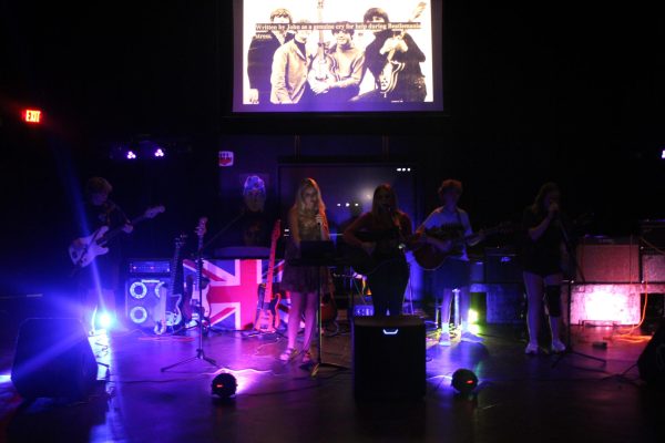 Beetlemania… Students perform the Beatles song “Help!” before transitioning into their cover of the hit album “Rubber Soul.” Slides behind the history of each song were displayed and students learned at least a fact about each song. (Riley Wootten)