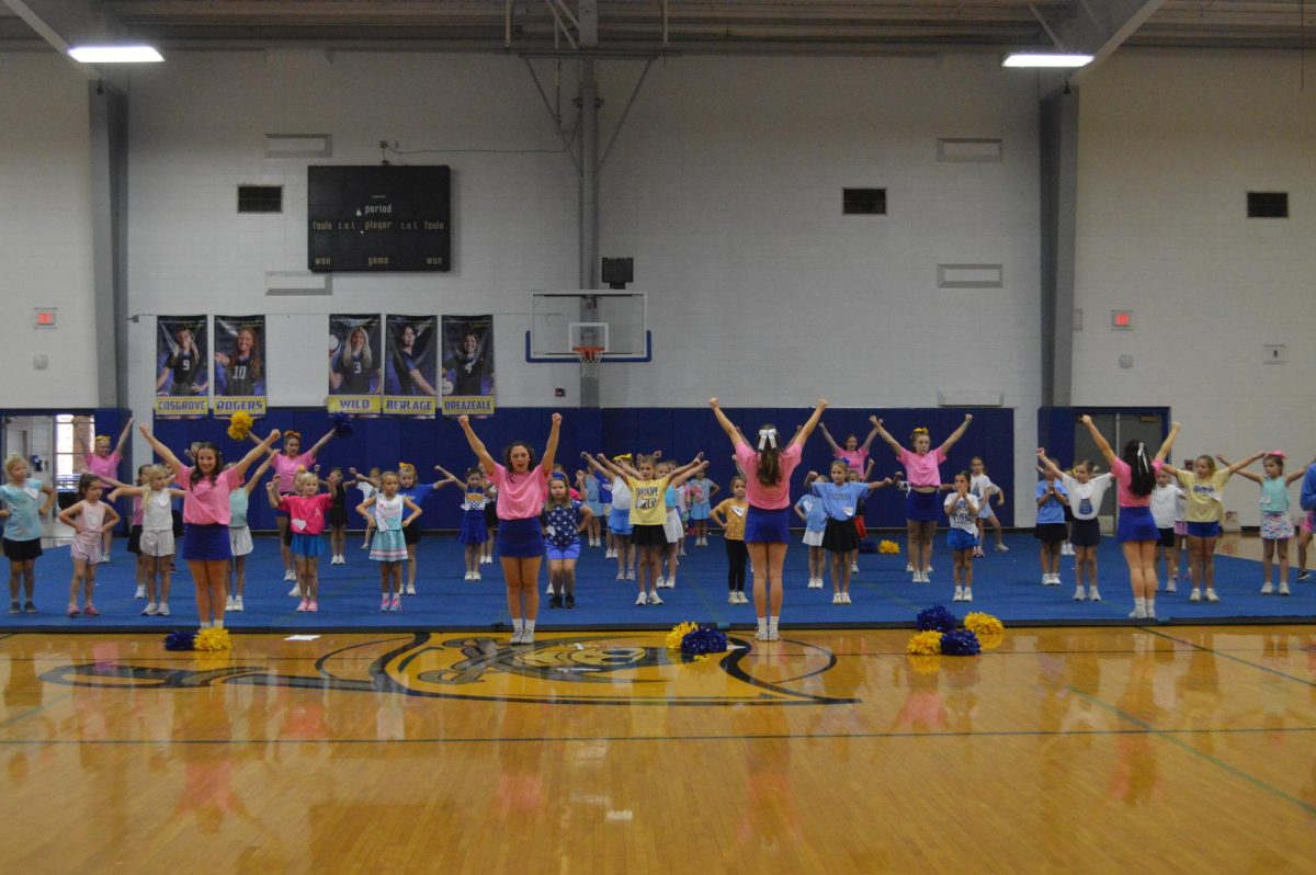 5,6,7,8….. Fairhope cheerleaders lead the little Pirates in the basics of jumps. Cheerleaders taught stunts, chants and dancing. (Madden Lewis)