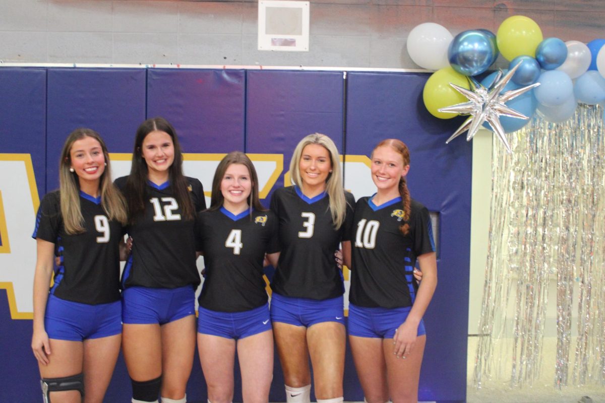 Senior takeover… Seniors prepare to take the court for their senior night game versus St. Luke Episcopal School on Oct. 2. All five seniors played volleyball at Fairhope throughout their high school careers. (Abigail Robinson)