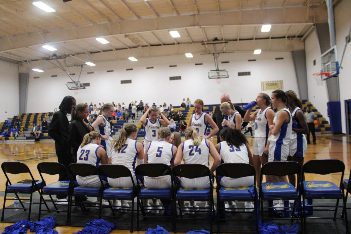 Lean in… The Lady Pirates discussed plays to run during a timeout. After the timeout, the Lady Pirates scored to maintain the lead. (Madden Lewis)