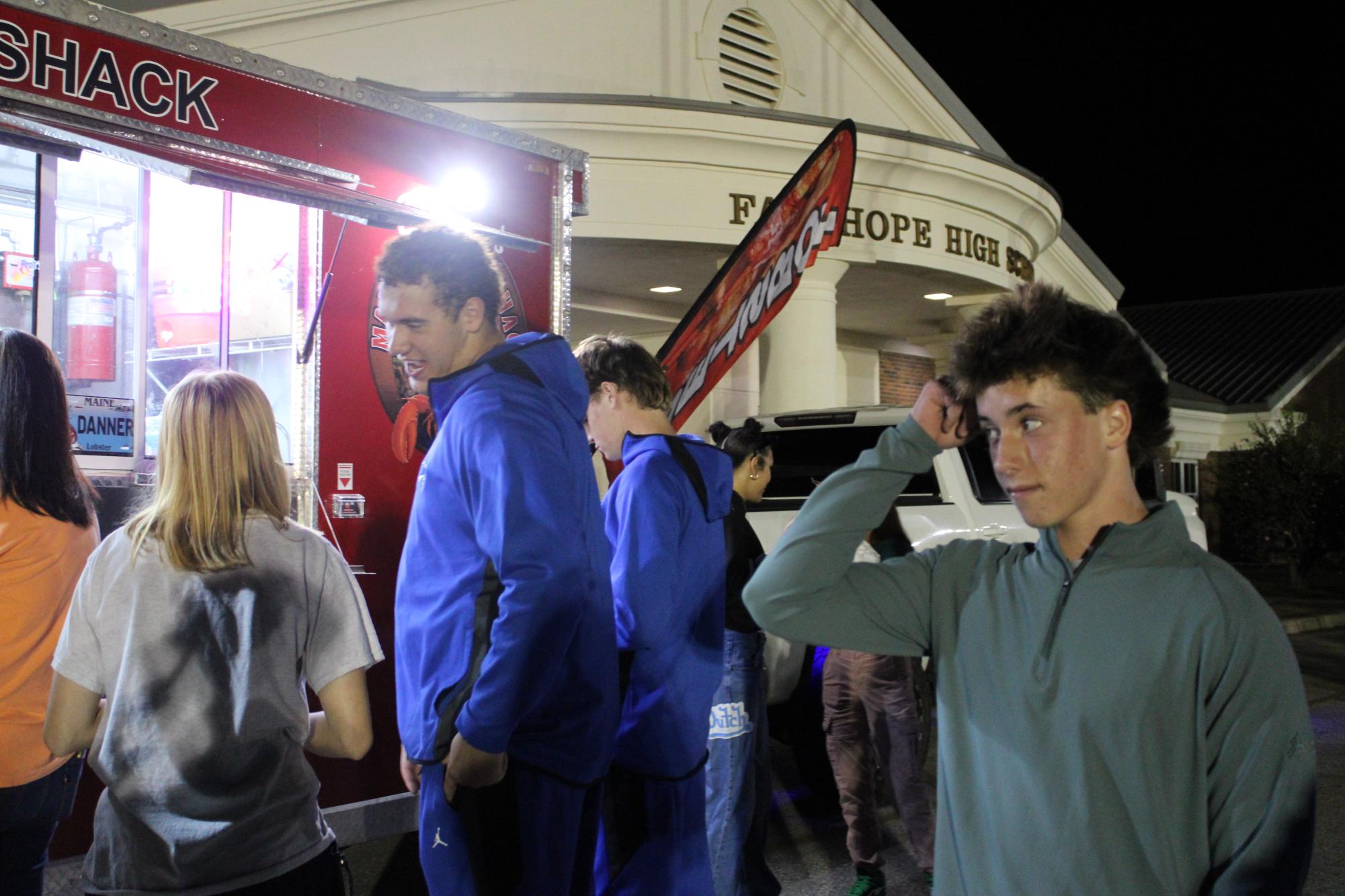 So many options…Freshman Tucker Norris contemplates what to order at the Lobster Shack food truck. Fairhope local small businesses sold food at the event. (Kendall Kirchoff)