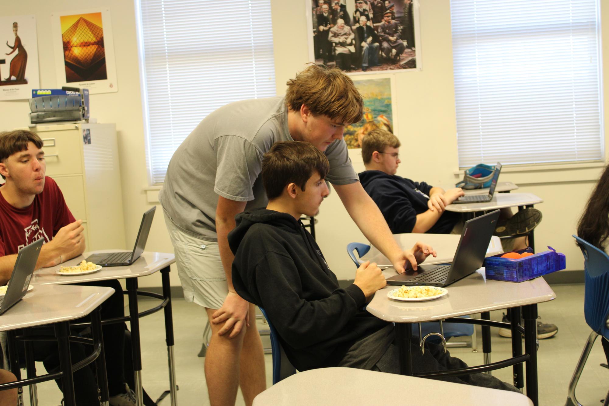 Helping Hands…Underwood assists club member James Watford with using the OnShape technology. (Halle Smith)