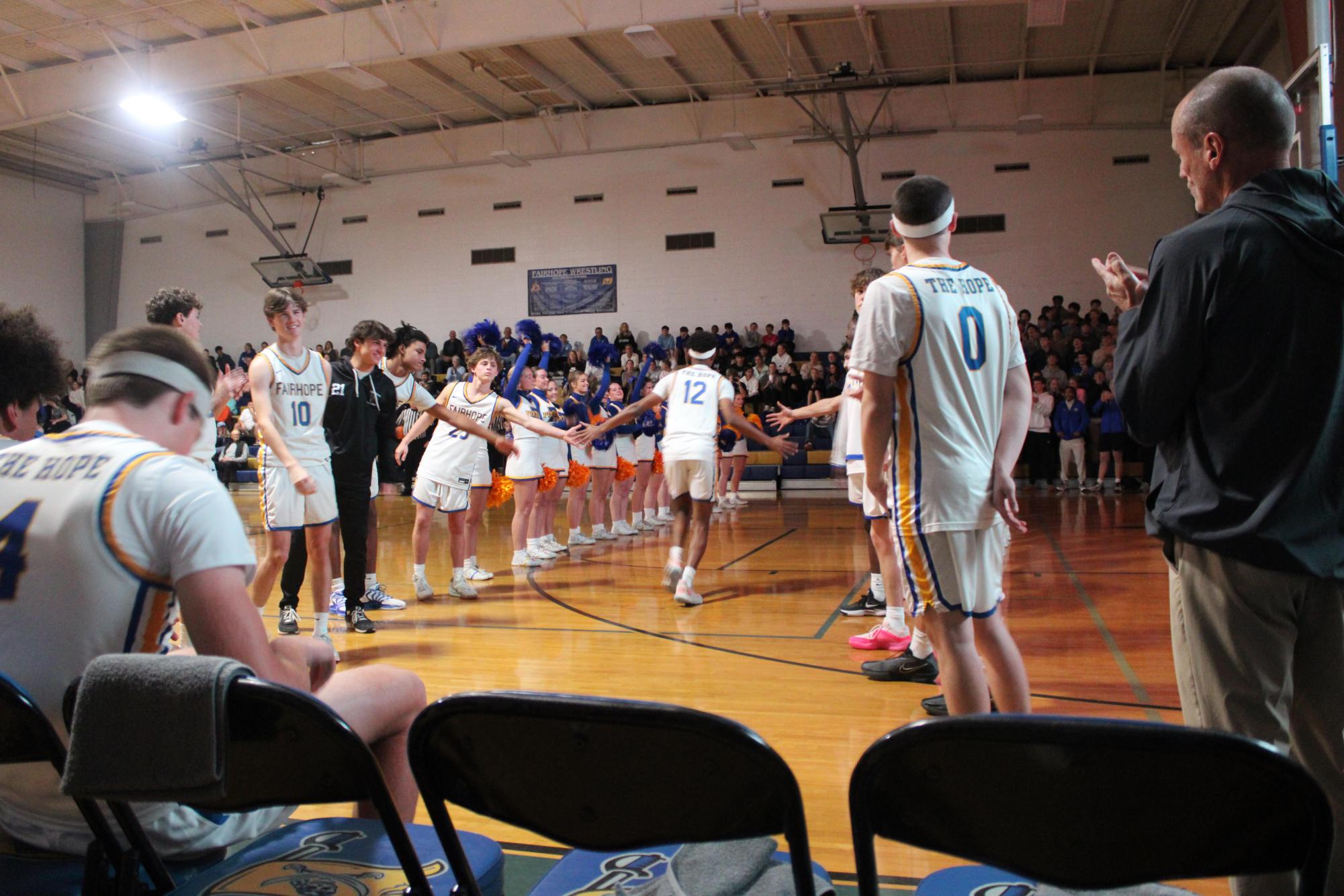 Game face on…Fairhope High School’s cheer squad cheers on the team as the starting lineup is announced. The Pirates huddled up shortly after to discuss the game plans. 