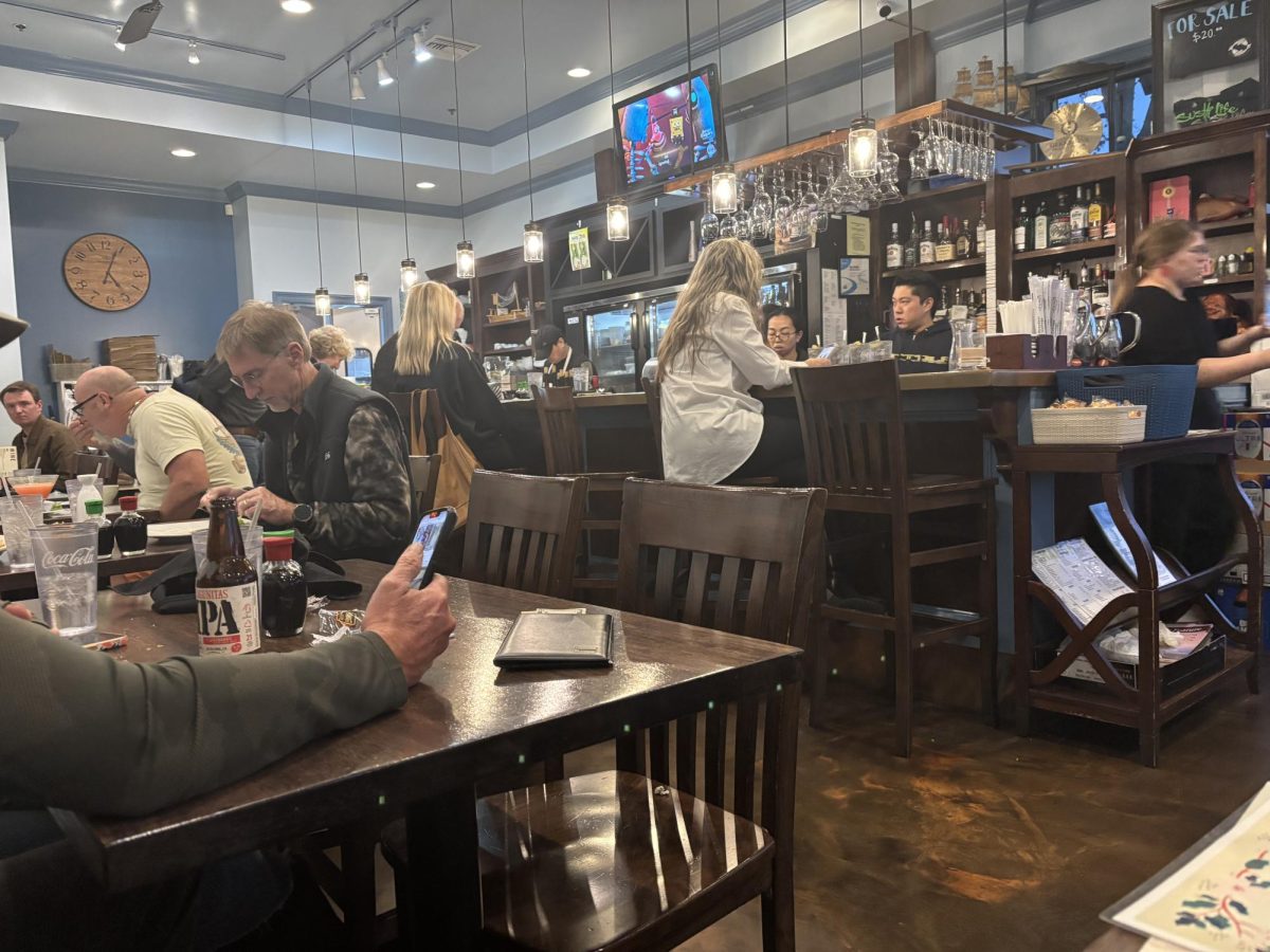 Cute and cozy. Customers scan their menus for entrees at the bar and small tables. (Lucy McIntosh)
