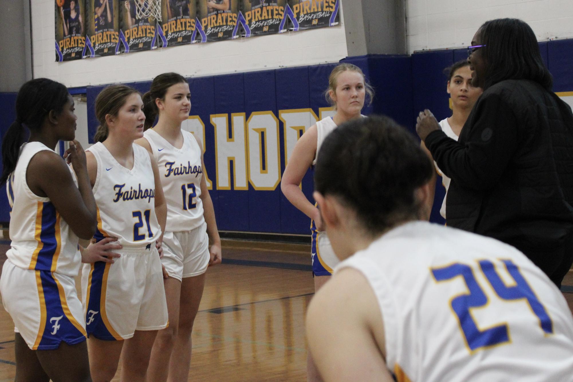 Pirates on three…Cassandra Agee, junior varsity coach, offers words of encouragement to her girls as they prepare for the game. Agee called two more timeouts during the remainder of the game. (Audrey Parsons)