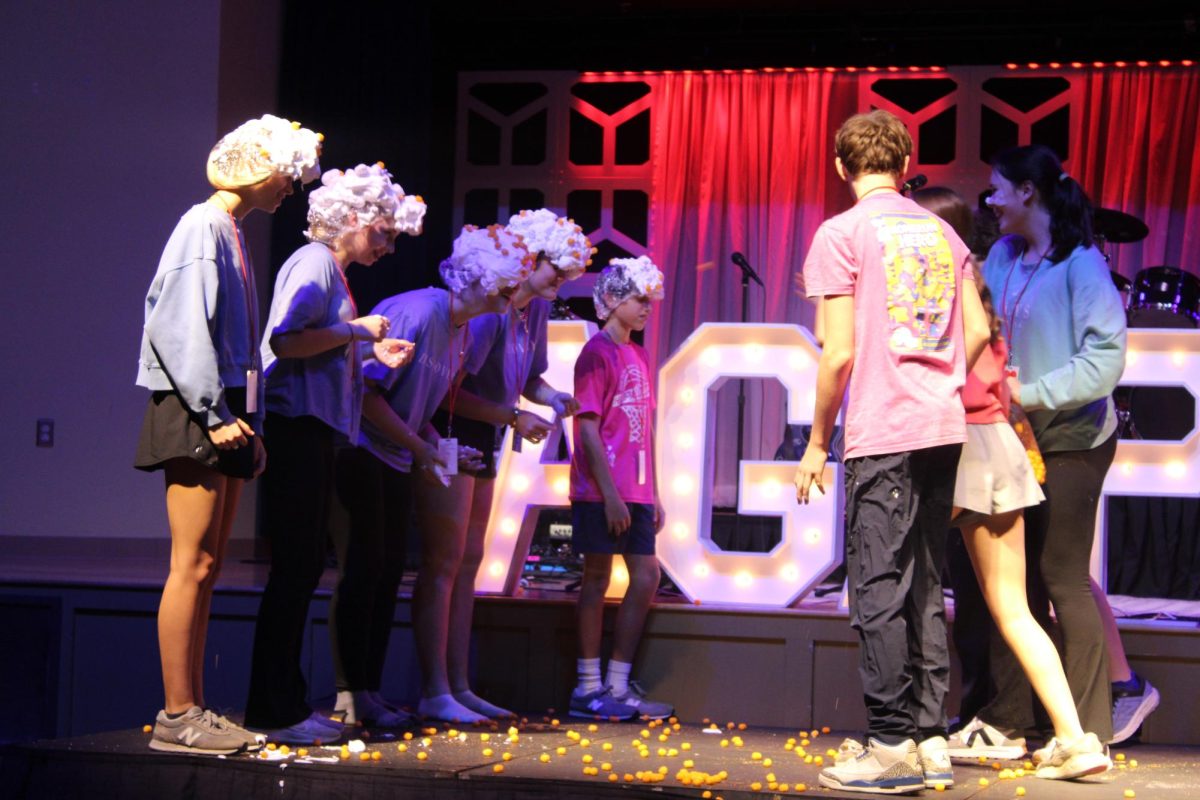 Cheese balls…Discovery Weekend attendants play a game with cheese balls and shaving cream. Middle schoolers threw cheese balls on their partner’s head, covered with shaving cream, to earn points towards their team winning. (Sydney Melanson)