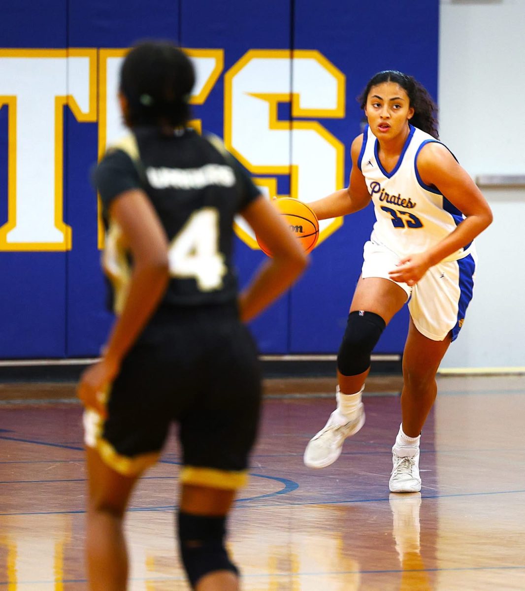 Drive...Junior Nylah Loukides focuses on the goal ahead of her, guarding the ball from the possession of the Theodore Bobcats. Loukides passed the ball to Campbell Anderson who shot within the paint to earn the Lady Pirates two points. (Jack Reid)