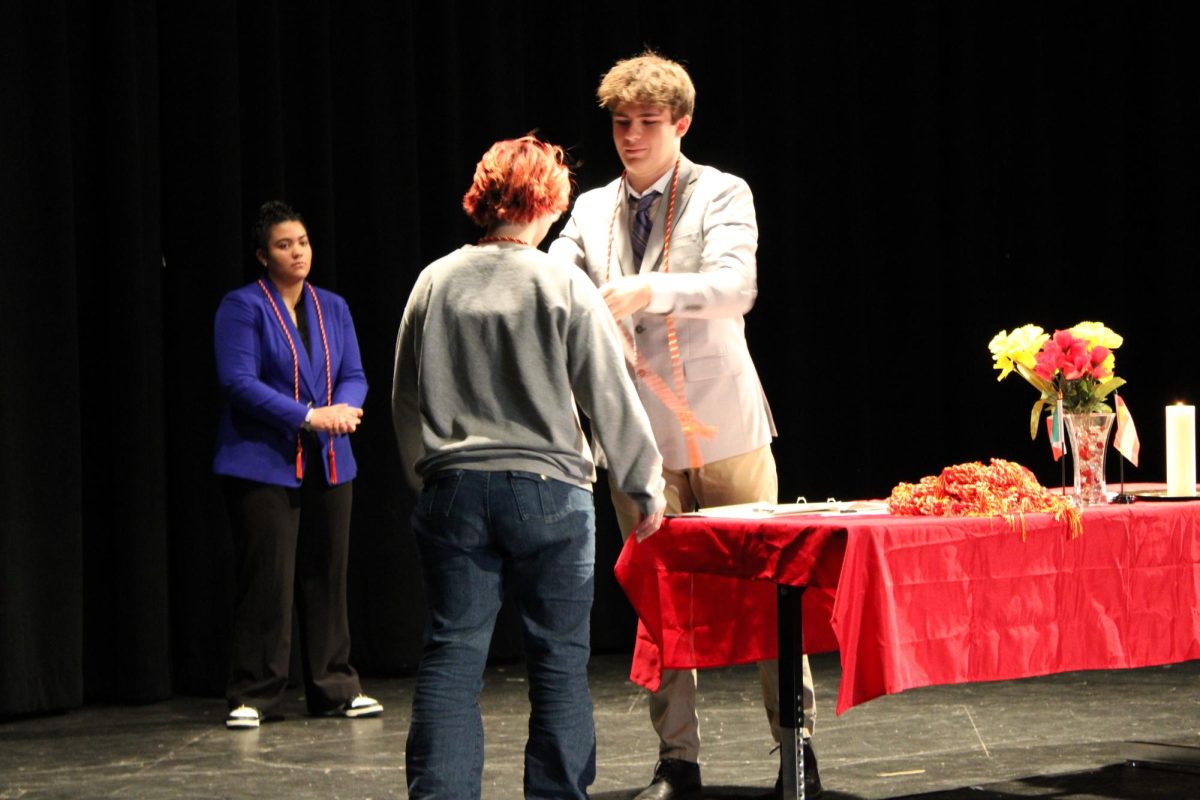 Congrats Pirates…Treasurer, Pieter Slinkman cords senior Rylee Mohler. Each senior received a cord to wear at graduation as a symbol of their high ideals and inspiration for the Spanish language. (Kendall Kirchoff)