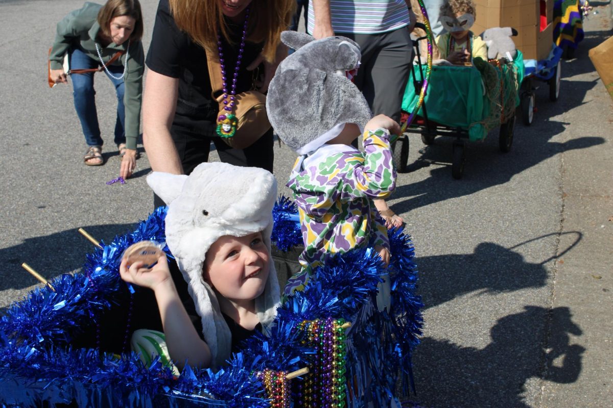 Friday February 14, Preschool students hosted a Mardi Gras themed parade in front of Fairhope High School for Operation Jubilee students. Preschool student Keegan Hall throws moon pies to the freshman boys. The float theme was “Under the Sea” and students dressed as sea animals. “They’ve been talking all day about their floats, what they were wearing and how they decorated them with their moms and dads,” said Christy Carson, pre-k teacher. (Kendall Kirchoff)
