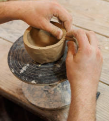Shaping clay… Bishop shaped the clay with his hands. He makes a mug for his wife as a surprise. (Apple Gaston)