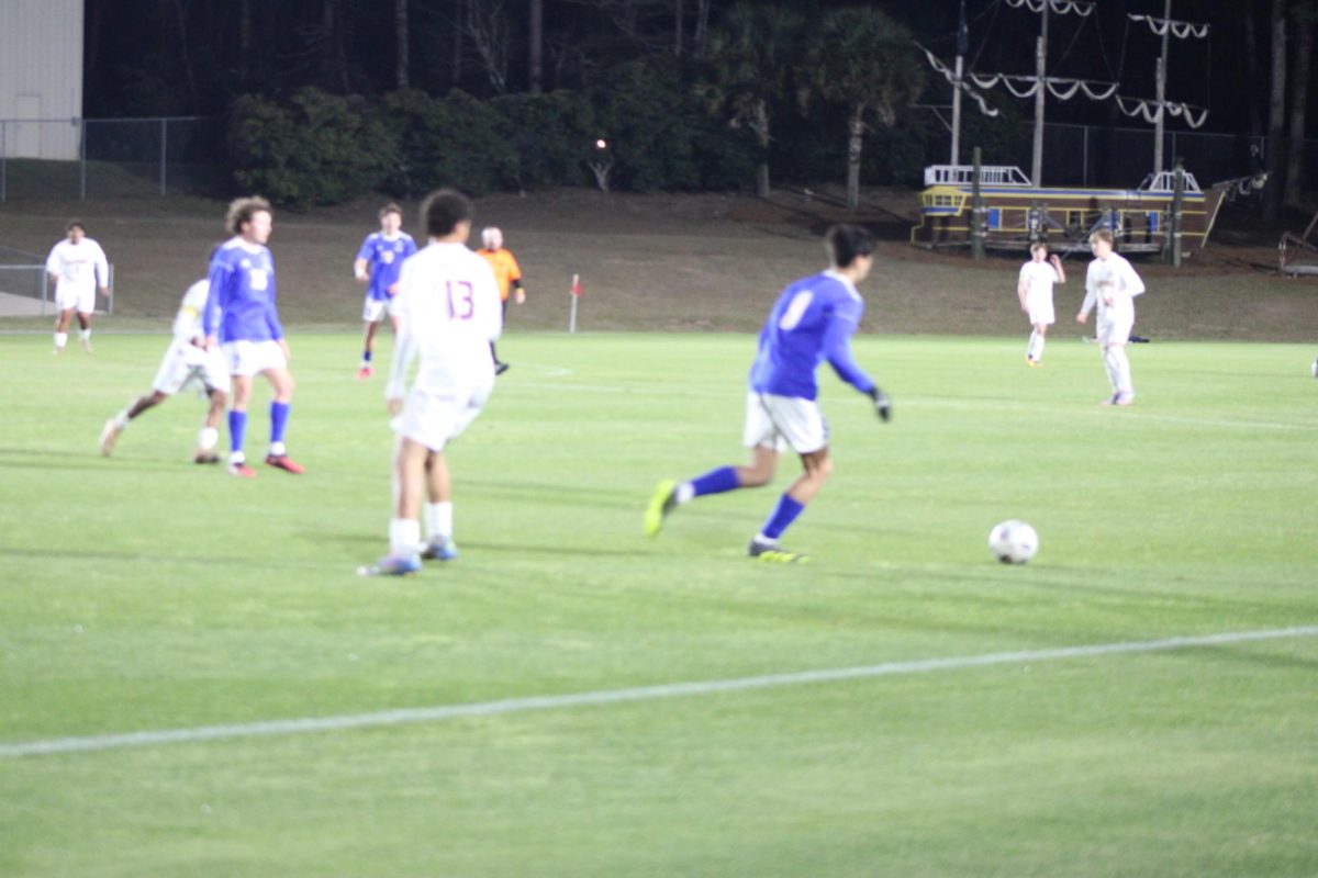 Dribbling down… Midfielder Trent Thompson moves the ball through the middle of the field. This advanced the ball down the field and kept players open. (Riley Wootten)