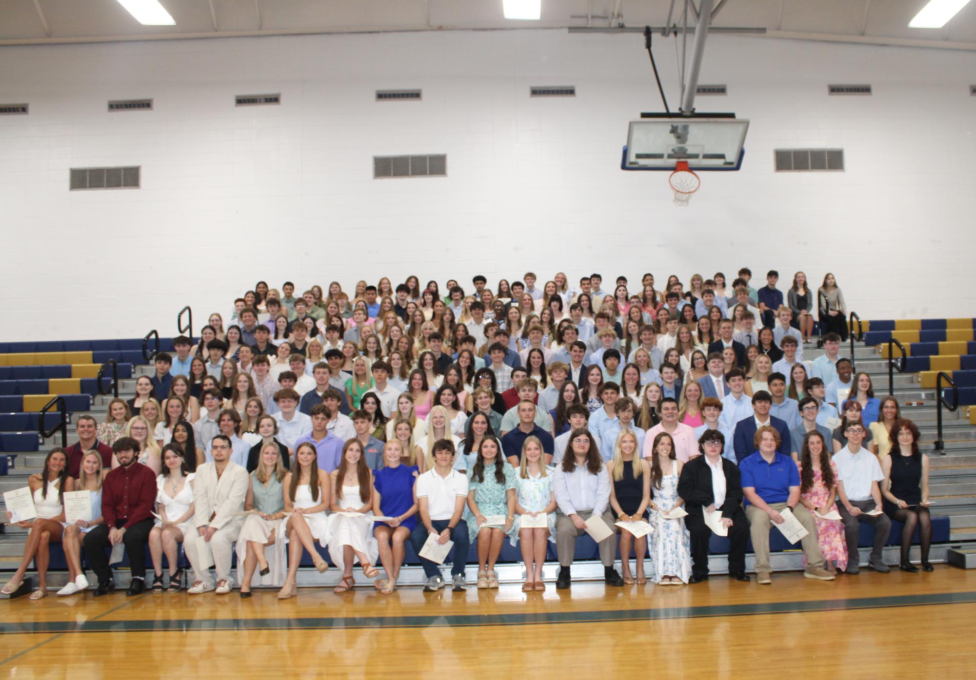 Welcome… the 217 inductees pose for a photo with their certificates. Brewer thanked the inductees for their hard work and attendance. 
