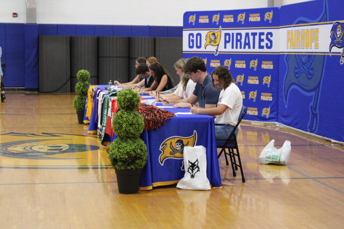 Signing Success… Students sign their commitment to their University. Students stayed after and celebrated their achievements. (Riley Wootten)