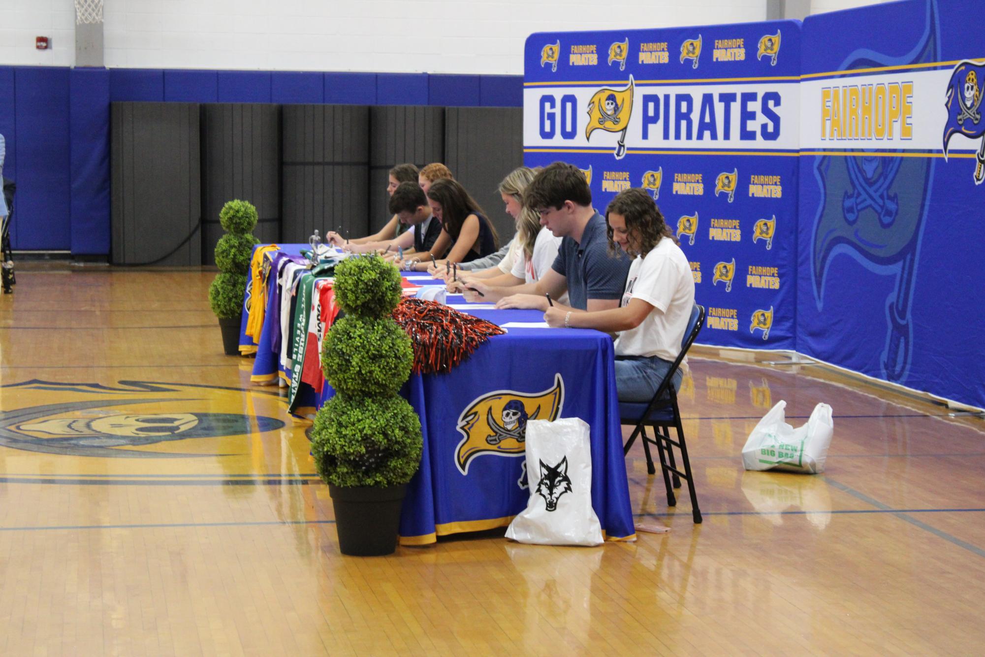 Signing Success… Students sign their commitment to their University. Students stayed after and celebrated their achievements. (Riley Wootten)